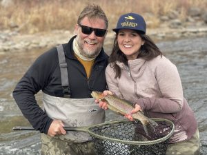 Eagle river guide with smiling client holding trophy trout